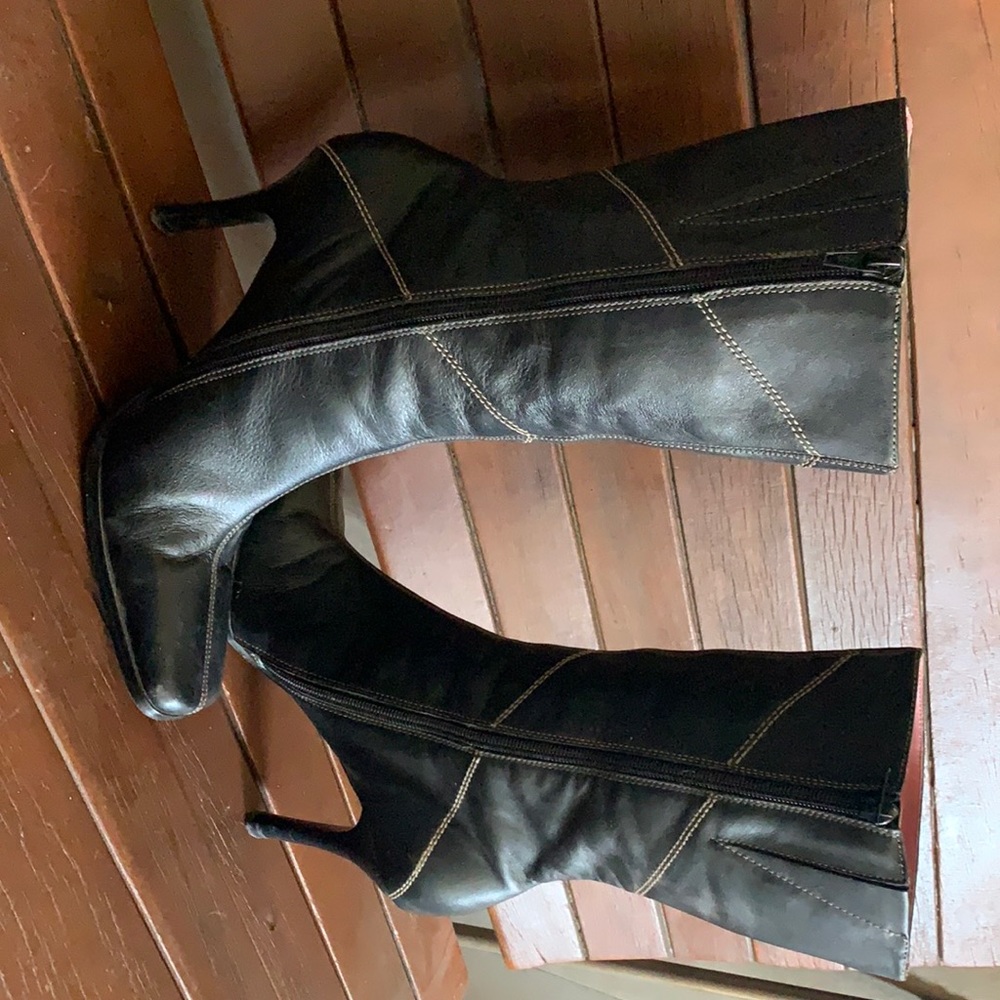 Black leather boots with stitching.